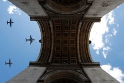 Military aircrafts fly over the Arc de Triomphe during a rehearsal for the Bastille Day celebrations in Paris, France, July 9. 2020.