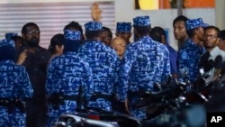 FILE - Policemen arrest former Maldives president and opposition leader Maumoon Abdul Gayoom, center, after the government declared a 15-day state of emergency in Male, Maldives, Feb. 6, 2018. 