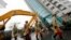 Rescuers work on a search operation at an apartment building that collapsed after a strong earthquake in Hualien County, eastern Taiwan, Feb. 7, 2018. A magnitude 6.4 earthquake struck late Tuesday night caused several buildings to cave in and tilt dangerously. 