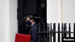 Britain's Chancellor of the Exchequer Rishi Sunak leaves Downing Street in London, Oct. 20, 2020.