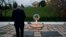 Attorney General Eric Holder pays his respects at the grave of John F. Kennedy at Arlington National Cemetery, Nov. 22, 2013, on the 50th anniversary of Kennedy's death. 