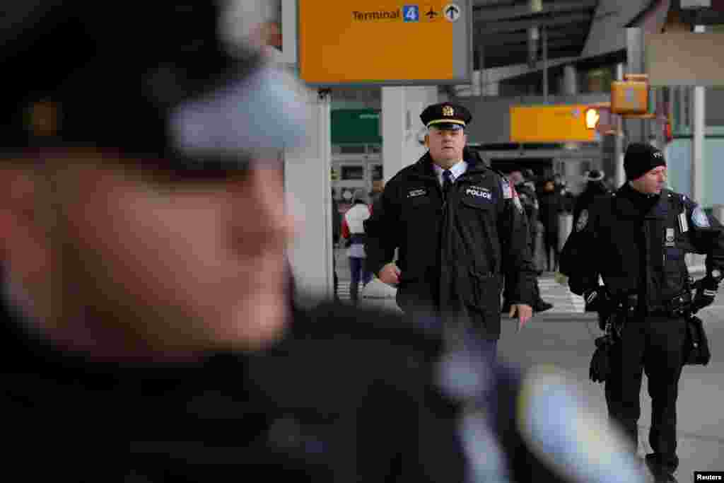 Police guard an entrance during anti-Donald Trump immigration ban protests outside Terminal 4 at John F. Kennedy International Airport in Queens, New York, Jan. 28, 2017. 
