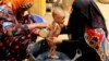 FILE - A severely malnourished infant is bathed in a bucket in Aslam, Hajjah, Yemen, Aug. 25, 2018.