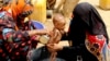 FILE - A severely malnourished infant is bathed in a bucket in Aslam, Hajjah, Yemen, Aug. 25, 2018.