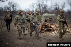 FILE - Ukraine's President Volodymyr Zelenskiy visits positions of armed forces near the frontline with Russian-backed separatists during his working trip in Donbass region, Ukraine, April 8, 2021.