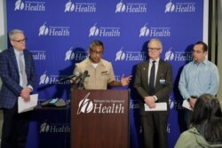Dr. Satish Pillai, at podium, a medical officer with the U.S. Centers for Disease Control and Prevention, speaks along with other officials, Jan. 22, 2020, during a news conference in Shoreline, Wash.