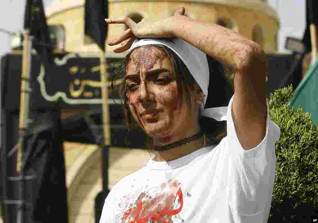 Seorang perempuan Muslim Syiah di Lebanon melukai kepalanya sendiri untuk menunjukkan rasa luka dalam ritual Ashura di Nabatieh (12/10). (AP/Mohammed Zaatari)