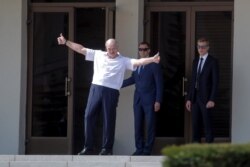 Belarusian President Alexander Lukashenko gestures as he greets his supporters gathered at Independent Square of Minsk, Belarus, Aug. 16, 2020.
