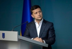 FILE - Ukrainian President Volodymyr Zelenskiy is pictured in a meeting with law enforcement officers in Kyiv, Ukraine, July 23, 2019.
