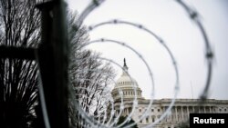 FILE PHOTO: Barbed wire and security fencing surrounds the U.S. Capitol in Washington, Jan. 26, 2021.