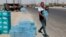 FILE - A man buys drinking water in Basra, southeast of Baghdad, Iraq, July, 21, 2019. 