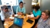 FILE - Juan Lopez, left, sits with fellow Honduran environmental activists during an interview in Washington, D.C. Oct. 3, 2019.