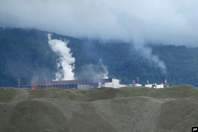 Indonesia Weda Bay Industrial Park operates in the background at Central Halmahera, North Maluku province, Indonesia, Saturday, June 8, 2024. (AP Photo/Achmad Ibrahim)