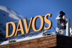 A policeman wearing camouflage clothing stands on the rooftop of a hotel near the Congress Centre during the World Economic Forum (WEF) annual meeting in Davos, Jan. 20, 2020.