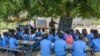 FILE - A teacher conducts his class under a tree in the village of Moho, Cameroon, Sept. 16, 2016. Thousands of teachers and other workers across Cameroon observed International Labor Day, on May 1, 2024, by protesting poor working conditions and low pay.