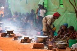 Refugees from Burundi who fled the ongoing violence and political tension prepare meals at the Nyarugusu refugee camp in western Tanzania, May 28, 2015.