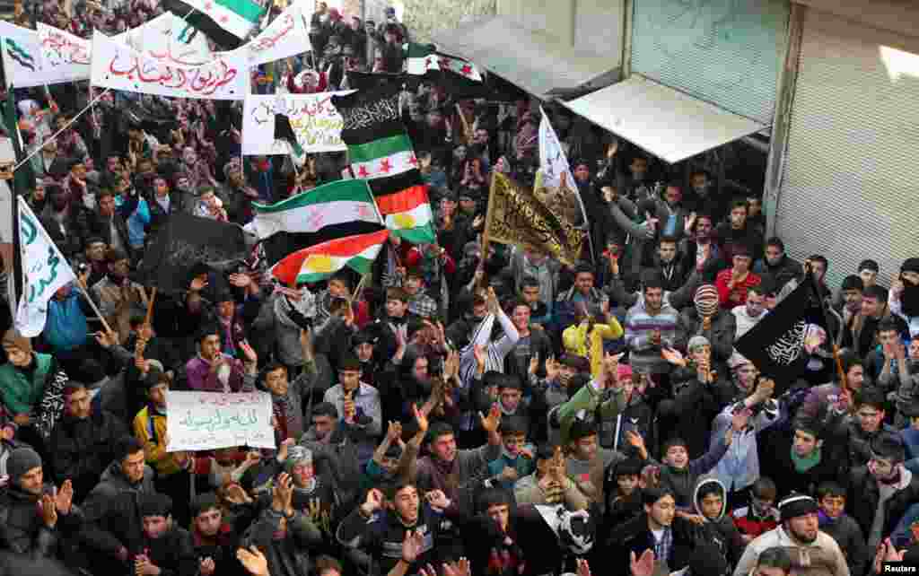 Demonstrators during a protest against Syria's President Bashar al-Assad in Aleppo's al-Sha'ar district, January 25, 2013.  