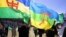 FILE - Demonstrators wave Berber flags in Agouni Arouss, Algeria, April 18, 2002. Suspected members of MAK, a group seeking independence for the Berber-speaking Kabylie region, were arrested after attacks in Algeria, police said Sept. 6, 2021.