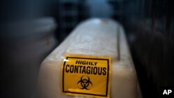 A sealed coffin containing the remains of a COVID-19 victim is stored in a refrigerated container in Johannesburg, South Africa, Feb. 2, 2021. 