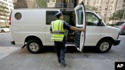 A New York City police officer examines a commercial vehicle at a checkpoint on 59th Street and Park Avenue in Manhattan, New York, September 9, 2011.