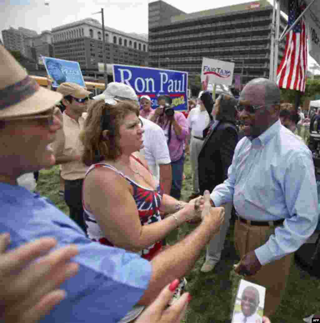 Republican presidential candidate Herman Cain shakes hands with supporters during the "Energy Independence Day Tea Party" rally on Independence Mall in Philadelphia, on Monday July 4, 2011. (AP Photo/Joseph Kaczmarek)