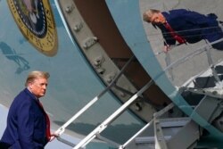 President Donald Trump boards Air Force One at Palm Beach International Airport, in West Palm Beach, Florida, Dec. 31, 2020.