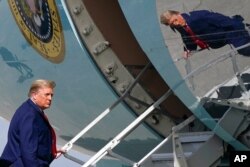 President Donald Trump boards Air Force One at Palm Beach International Airport, in West Palm Beach, Florida, Dec. 31, 2020.