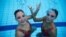 FILE - Brazil's synchronized swimmers Luisa Borges (R) and Maria Eduarda Miccuci pose for a photograph after a training session at the Rio Olympic Park in Rio de Janeiro, Brazil, April 7, 2016.
