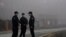 Security personnel stand guard near the Wuhan Institute of Virology after a World Health Organization team arrived for a field visit in Wuhan in China's Hubei province Wednesday, Feb. 3, 2021. The WHO team is investigating the origins of the…