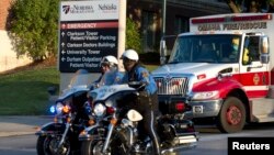 An ambulance transports Ashoka Mukpo, a freelance cameraman who contracted Ebola in Liberia, to the Nebraska Medical Center in Omaha, Nebraska, Oct. 6, 2014. 