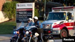 An ambulance transports Ashoka Mukpo, a freelance cameraman who contracted Ebola in Liberia, to the Nebraska Medical Center in Omaha, Nebraska, Oct. 6, 2014. 