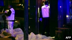 Victims lay on the pavement outside a Paris restaurant, Nov. 13, 2015.