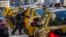 FILE - A woman exits a taxi on Third Avenue in heavy traffic caused in New York, Sept. 24, 2013. 