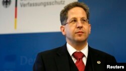 FILE - President of Germany's intelligence agency Verfassungsschutz Hans-Georg Maassen listens during a visit by German Interior Minister Thomas de Maiziere at the Federal Office for the Protection of the Constitution in Cologne.