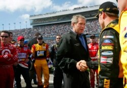 FILE - In this Feb. 15, 2004, photo, then-President George W. Bush greets driver Matt Kenseth in the pits at the Daytona 500 NASCAR race in Daytona Beach, Fla.