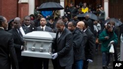 FILE - Pallbearers carry the casket of Akai Gurley during his funeral in Brooklyn, N.Y., in December; New York City Police Officer Peter Liang reportedly has been indicted in the fatal shooting of Gurley.