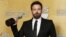 Director and actor Ben Affleck holds the award for outstanding performance by a cast in a motion picture for "Argo" at the 19th annual Screen Actors Guild Awards in Los Angeles, California January 27, 2013.