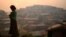 FILE - A Rohingya refugee is seen in Balukhali refugee camp at dawn near Cox's Bazaar, Bangladesh, March 28, 2018. 