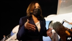 Vice President Kamala Harris talks to the press gathered under the wing of Air Force Two as she prepares to depart for Mexico, from Guatemala's Air Force Central Command, June 7, 2021. 