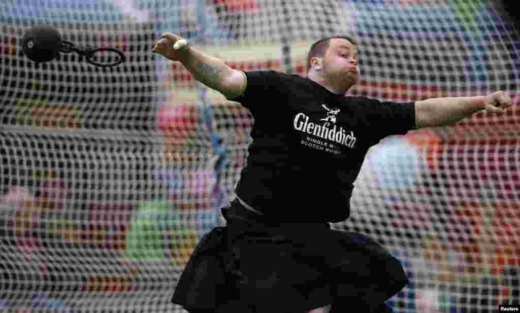 A competitor throws the weight in the Ballater Highland Games, in Monaltrie Park, Ballater, Scotland.