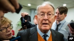 Sen. Lamar Alexander, R-Tenn., speaks to reporters as he arrives at the Capitol in Washington, Monday, Jan. 27, 2020, during the impeachment trial of President Donald Trump on charges of abuse of power and obstruction of Congress. (AP Photo/Manuel…
