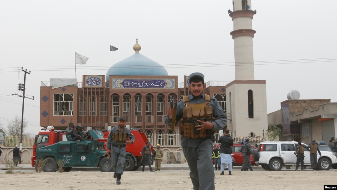 Afghan policemen patrol in front of the Baqir ul Olum mosque on Nov. 21, 2016. Dozens were killed and injured after a suicide bomb attack. 