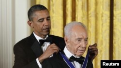 Presiden AS Barack Obama (kiri) menganugerahkan Medali Kebebasan untuk Presiden Israel Shimon Peres di Washington DC (13/6).