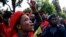 Members of the Economic Freedom Fighters (EFF) party sing during their march for economic reform outside the Johannesburg Stock Exchange, Oct. 27, 2015.