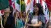 FILE - International students carry their national flags at the University of Missouri in Columbia, Missouri.