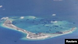 Chinese dredging vessels are purportedly seen in the waters around Mischief Reef in the disputed Spratly Islands in the South China Sea, May 21, 2015.