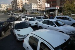 Vehicles line up to enter a gas station in Tehran, Iran, Nov. 15, 2019. Authorities have imposed rationing and increased the prices of fuel.
