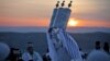 An elderly woman walks to a relative&#39;s grave at dawn in Copaciu, southern Romania.