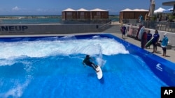 Ikaika Kaulukukui surfs in a wave pool in Ewa Beach, Hawaii, on May 9, 2023. (AP Photo/Jennifer Sinco Kelleher)