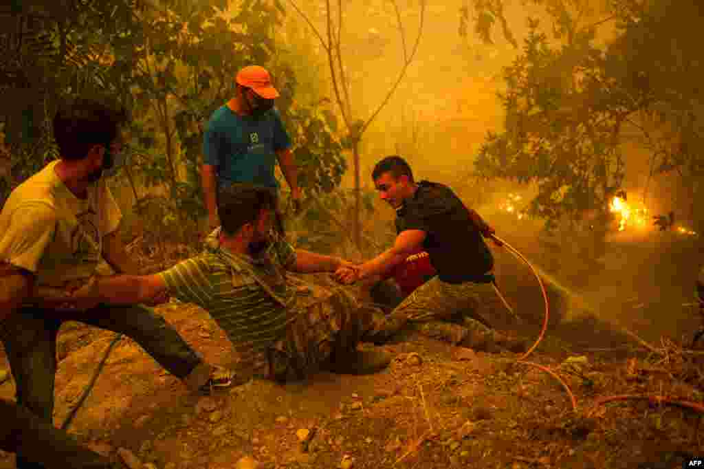 Local residents fight the wildfire in the village of Gouves on Evia (Euboea) island, second largest Greek island.